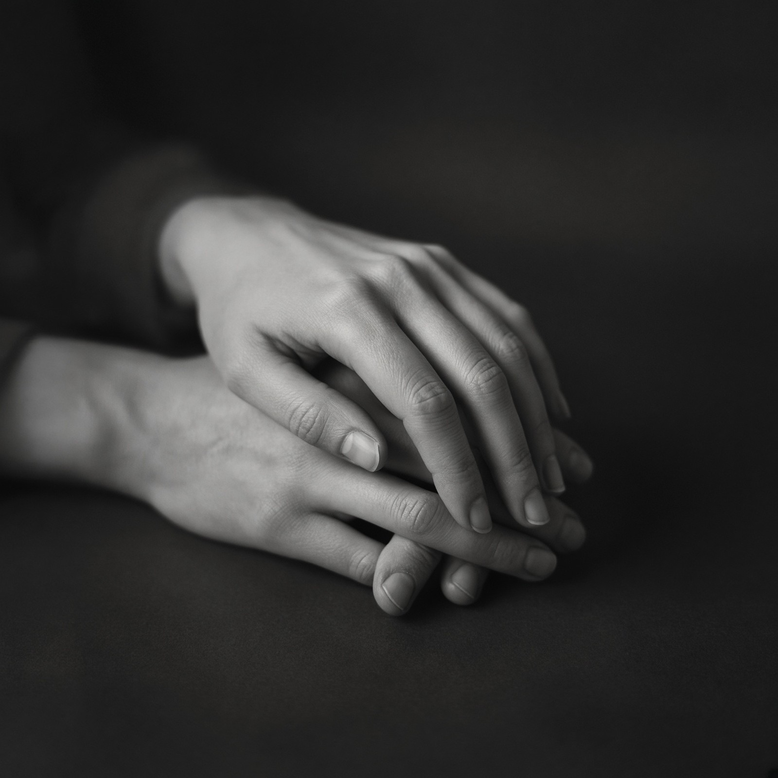 Hands folded together in a quiet rest